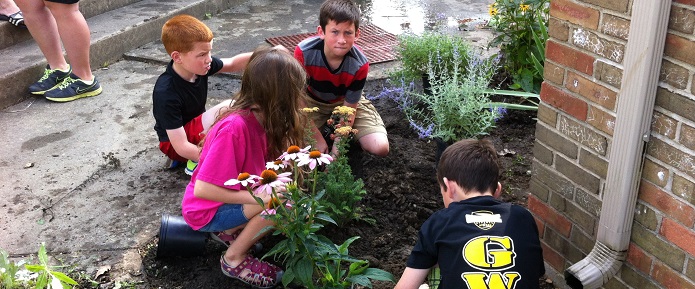 Children installing a rain garden